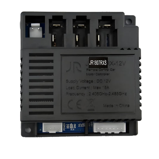 A black 12V Bluetooth receiver motor controller for kids' electric cars, with multiple connection ports and branding visible on the casing.
